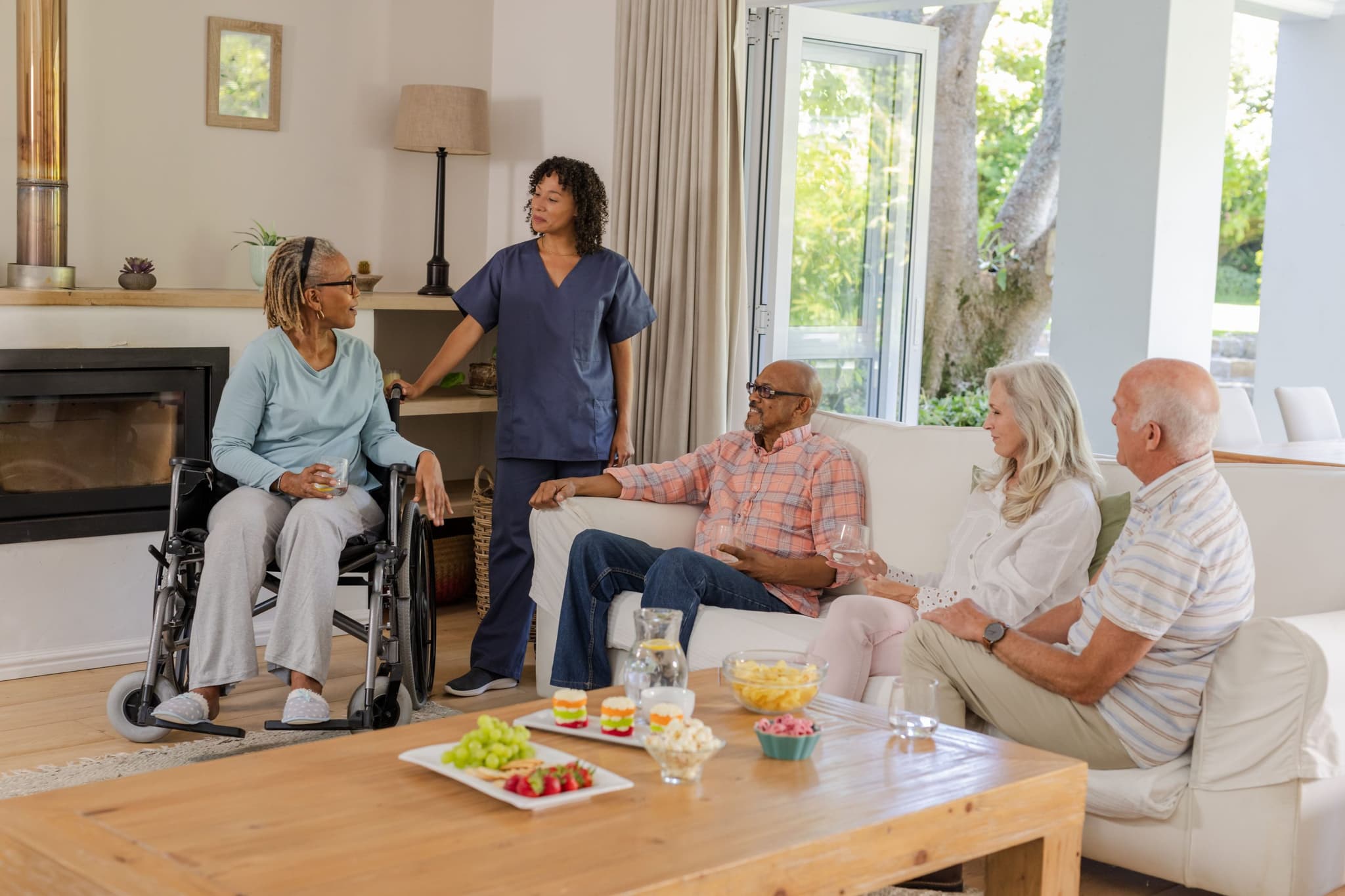 Caregiver in conversation with senior residents
